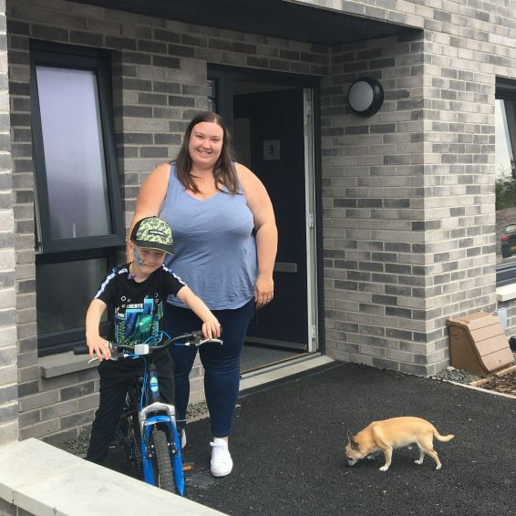 Lisa Kitson and her son at their new home