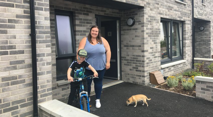 Lisa Kitson and her son at their new home