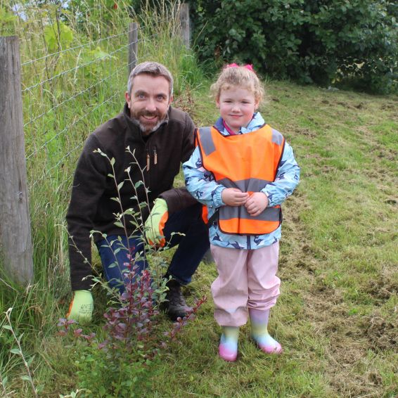Wheatley Group Chief Executive Steven Henderson plants trees with Olivia Woods, five, from Just Be Kids nursery in Darnley